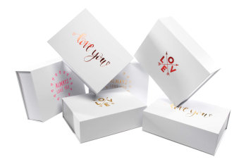 White gift boxes adorned with romantic gold lettering
