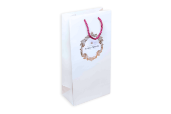 White paper bag with red handle and decorative logo