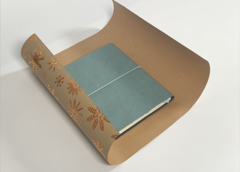 Book wrapped in festive gift paper with floral design