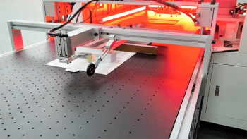 Automated packaging machine cuts and folds paper