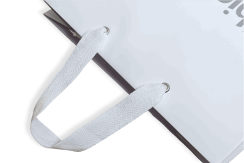 White paper bag with reinforced fabric carrying handles