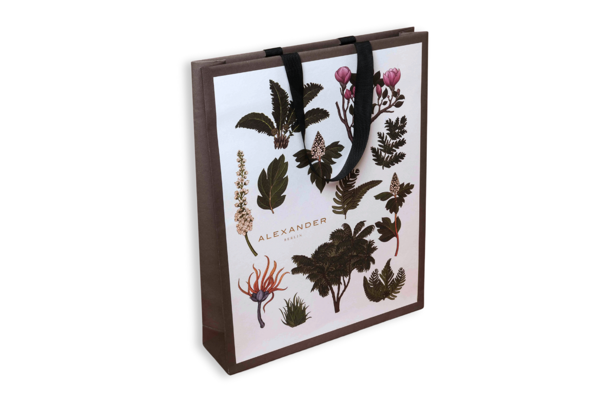 Paper bag with a plant pattern and black handles