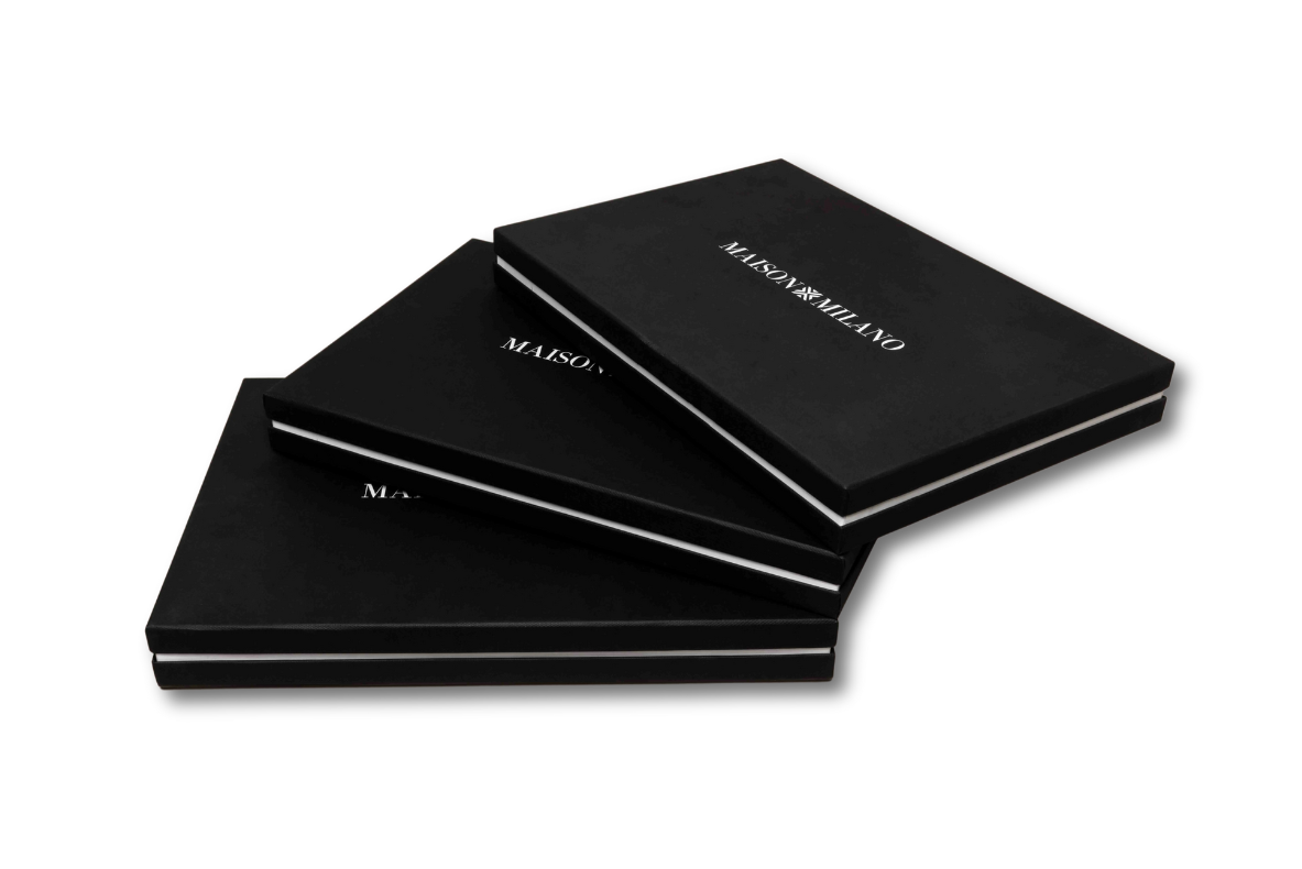 Black magnetic boxes stacked on a white background