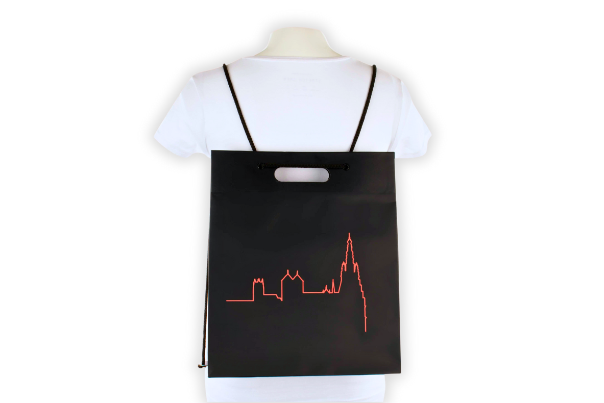 Black tote bag designed as a backpack with red city silhouette design