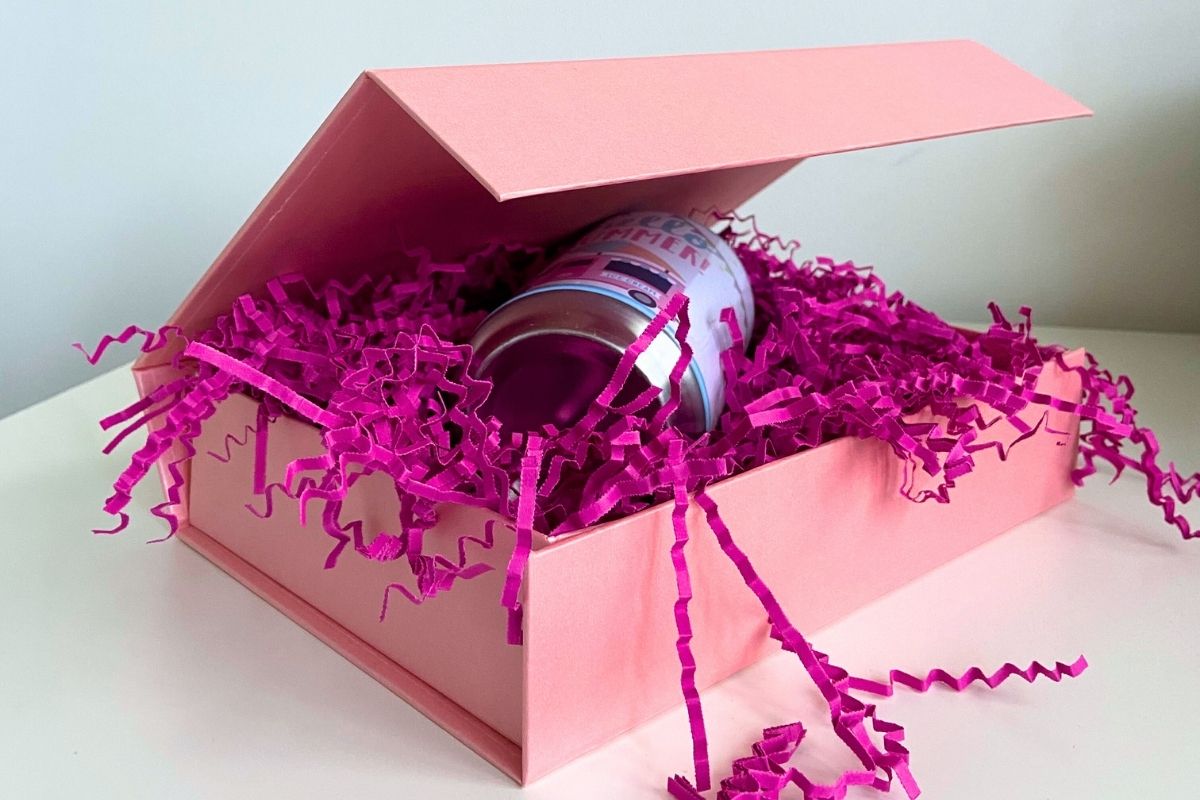 Pink magnetic box with purple filling material and a can inside